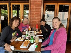 An image of indivisible members sitting together at a restaurant table